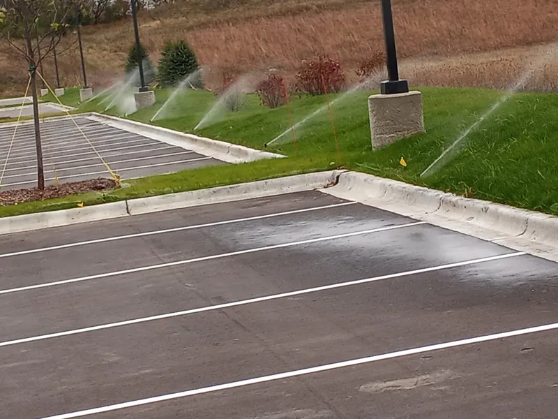 Commercial irrigation running on parking lot islands
